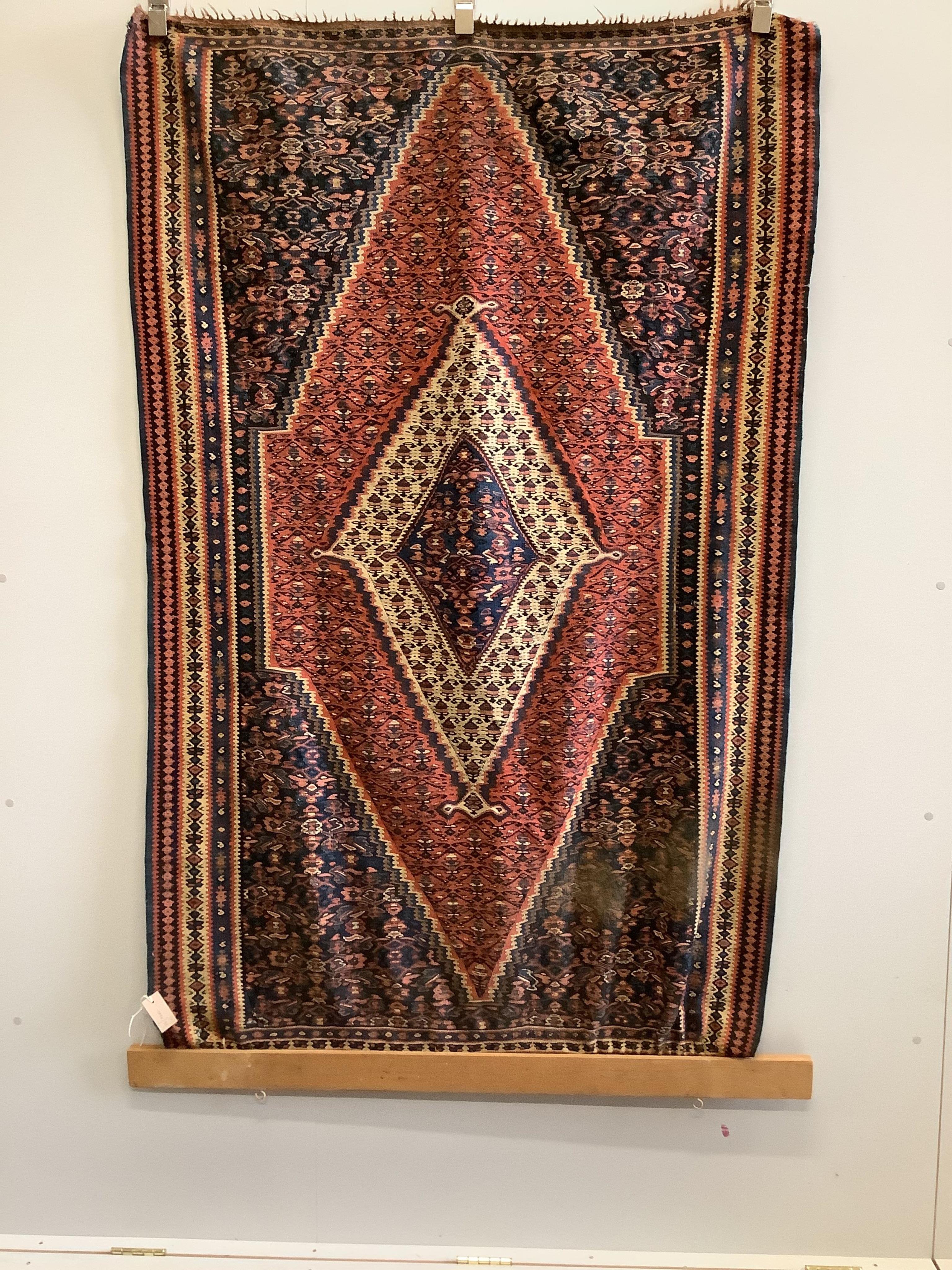 A near pair of antique Persian Senneh flatweave rugs, approximately 180 x 124cm. Condition - fair